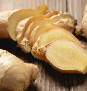 fresh-ginger-root-sliced-wooden-table_1150-18399